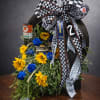 Funeral arrangement inside racing tire. Flowers may vary