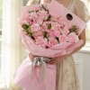 A graceful and elegant bouquet featuring soft pink roses, pink carnations, and