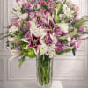 Large bouquet of pink and white flowers in a clear glass vase