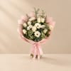 Pink-wrapped bouquet of white roses and daisies with a satin ribbon