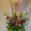 Tropical flower arrangement with bird of paradise and orchids in a pot