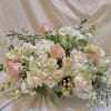 Blush and white floral arrangement with roses and hydrangeas
