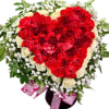 Heart-shaped bouquet of red and white roses with baby's breath