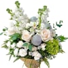 White floral arrangement with roses, orchids, and silver ornaments in a vase
