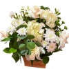 White and pale pink flowers arranged in a woven basket