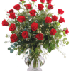 Red roses arranged in a clear glass vase