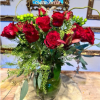 A DOZEN ROSES ARRANGED IN THE TALL VASE