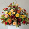 Mixed bouquet of roses, gerbera daisies, and chrysanthemums in a white vase