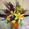 Colorful floral arrangement in a pumpkin-shaped container