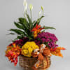 Autumn floral basket with white peace lilies, mums, and fall leaves