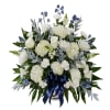 White floral spray with blue accents and a navy ribbon