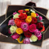 Hand-tied bouquet of mixed-color roses wrapped in black and gold paper