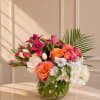 A vibrant floral arrangement featuring premium roses, lilies, tulips, hydrangeas, and tropical