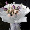 A graceful blend of tulips, stock flowers, and roses, this bouquet is