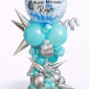 Tall birthday balloon arrangement in blue and silver with a large printed topper and star accents.