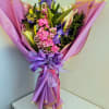 Tall purple iris soar above a lush cluster of white lilies and