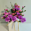 A confident burst of purple and pink carnations that brightens any birthday