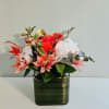 A compact tableau of soft pink daisies, large white blooms, and a