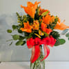 Vivid orange lilies take center stage in this Day Of Orange flower