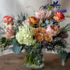 Soft coral. peach and pale yellows with pops of lavender and blue