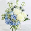 This serene and refreshing arrangement is a soothing blend of cool blue