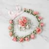 This delicate piece features a harmonious blend of blush pink roses and