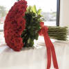 Large bouquet of red roses wrapped with a red ribbon