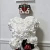 White teddy bear with a small rose bouquet and a "happy mother day" sign