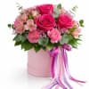 A charming arrangement of vibrant pink roses and delicate blooms presented in