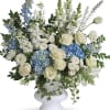 White and blue roses, hydrangeas and Stocks arranged with greenery in a