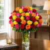 A densely clustered dome of two dozen mixed-color roses creates an immediate