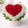 A striking heart of deep red roses forms the immediate focal point
