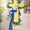 A gently reverent cross of pale yellow chrysanthemums creates the first, calming