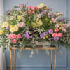 A soft, garden-fresh centerpiece designed for wedding ceremonies and receptions, this altar
