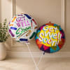 Cheerful paired foil balloons that say "Get Well Soon!" make an upbeat