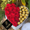 Heart-shaped box with red roses and gold-wrapped chocolates