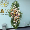 A tall, formal sympathy stand that offers a serene, pastel tribute for