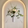 White, blush and peach roses with white accents and eucalyptus in a