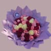 A lush hand-tied bouquet of roses in deep red, blush pink, creamy