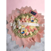 Pink and cream rose bouquet wrapped in blush paper with a ribbon