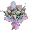Pastel bouquet of roses and tulips wrapped in pink paper