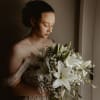 Simple and elegant bouquet of lilies, waxflower, and baby's breath 