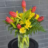 Upright red tulips paired with sunny yellow alstroemeria create a cheerful spring