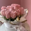 Pink roses presented in a "hat box" style arrangement.