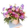 Lavender roses, purple Lisianthus, stock, mums, and carnations woven together in a