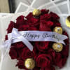 Tightly clustered deep red roses form a lush, rounded birthday bouquet that
