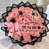 Pink rose bouquet with a ribbon and Halloween-themed decorations