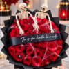 Red rose bouquet with two skeleton decorations and black wrapping