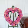 A tender heart-shaped sympathy wreath designed to honor a loved one with