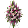 A grand and soaring floral tribute presented on a traditional easel. This